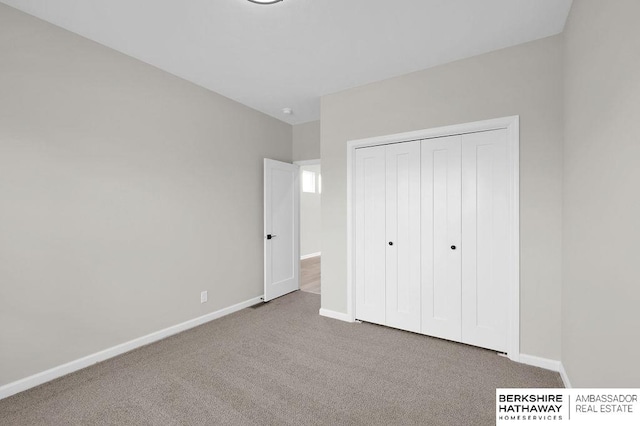 unfurnished bedroom with carpet floors and a closet