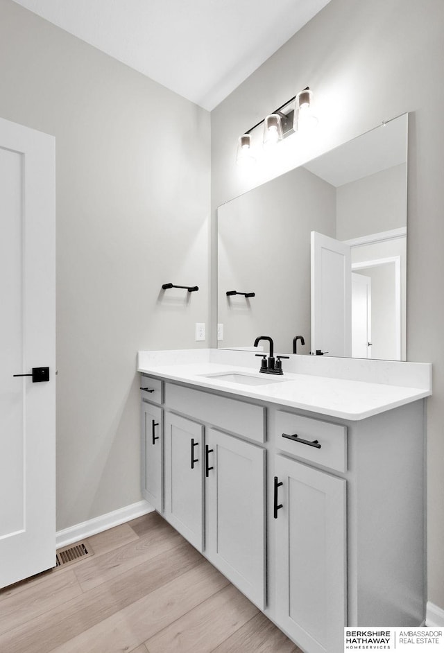 bathroom featuring vanity and hardwood / wood-style floors