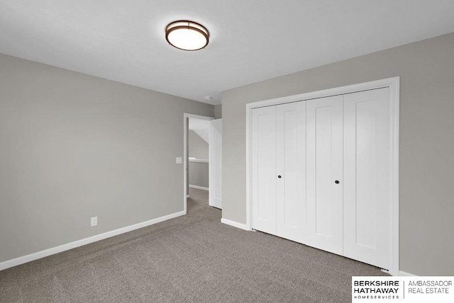 unfurnished bedroom featuring a closet and carpet