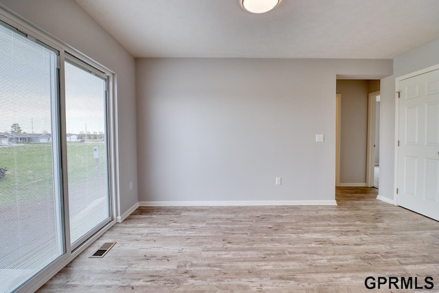 unfurnished room featuring light wood-type flooring