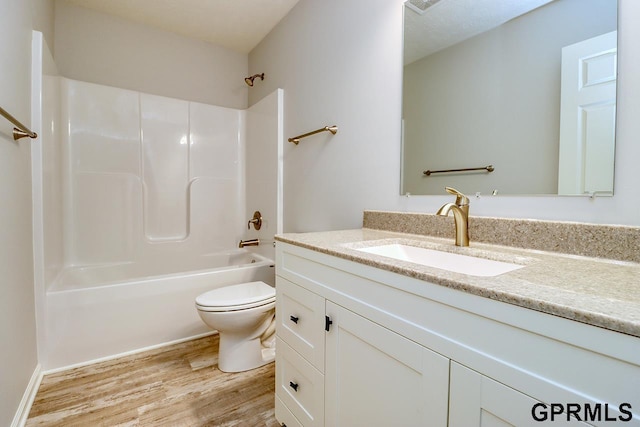 full bathroom featuring hardwood / wood-style flooring,  shower combination, vanity, and toilet