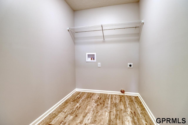 laundry area with hookup for a washing machine, hardwood / wood-style flooring, and hookup for an electric dryer