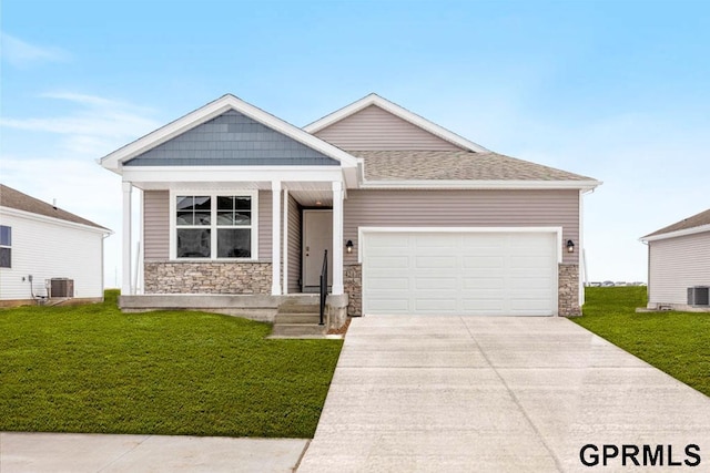 craftsman-style house featuring a garage, a front yard, and central AC