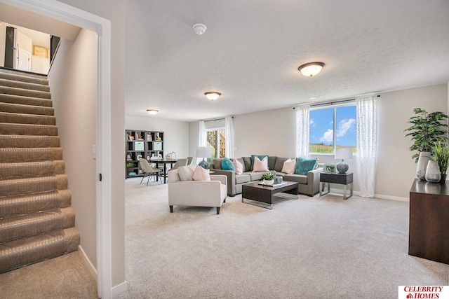 carpeted living room with a healthy amount of sunlight and a textured ceiling