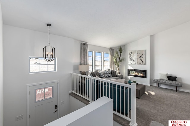 interior space with an inviting chandelier, carpet floors, and lofted ceiling