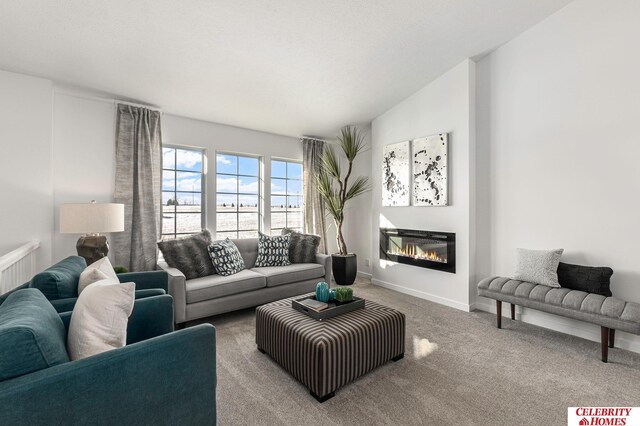 living room featuring lofted ceiling and carpet