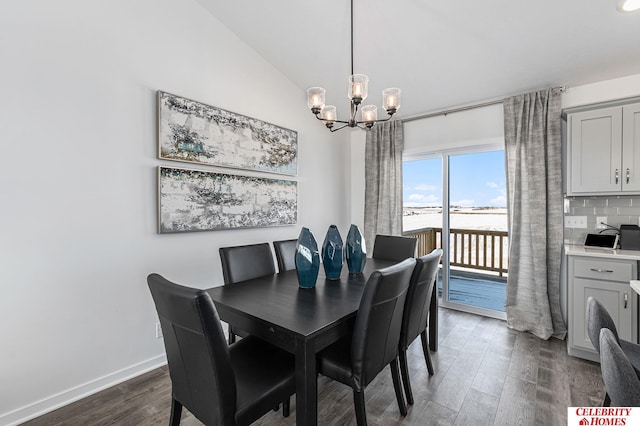 dining room featuring an inviting chandelier, dark hardwood / wood-style flooring, and vaulted ceiling