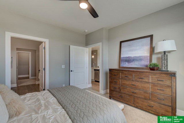 bedroom featuring dark colored carpet, ensuite bathroom, and ceiling fan