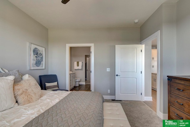 bedroom featuring dark carpet, ceiling fan, and connected bathroom