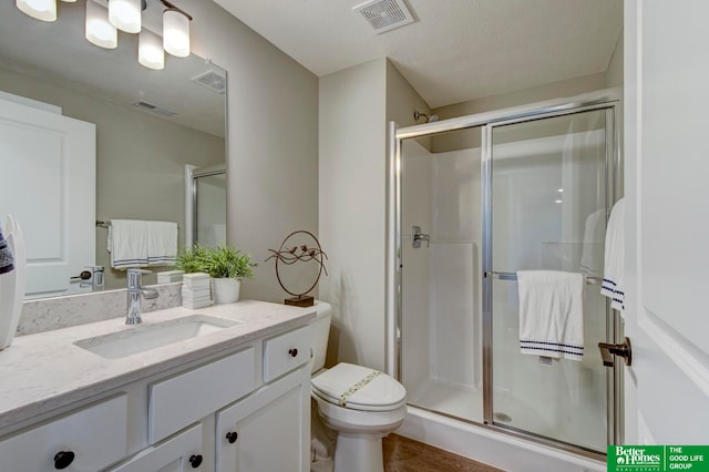 bathroom with walk in shower, a textured ceiling, toilet, and large vanity