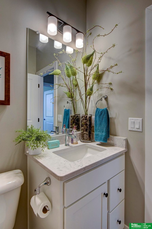 bathroom featuring large vanity and toilet