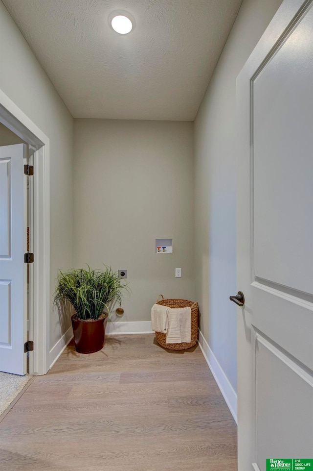 interior space with a textured ceiling and hardwood / wood-style floors