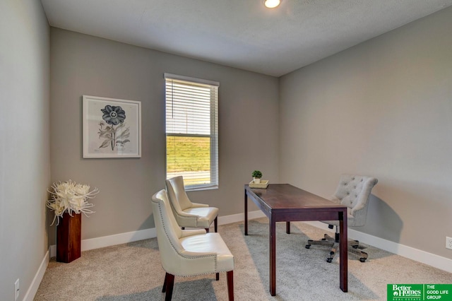 carpeted home office with a textured ceiling