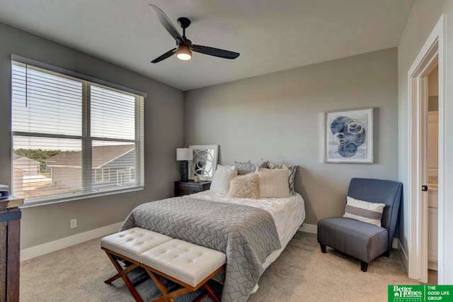 carpeted bedroom with connected bathroom and ceiling fan