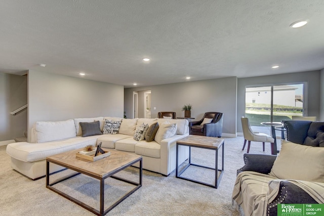 living area featuring baseboards, a textured ceiling, recessed lighting, and light carpet