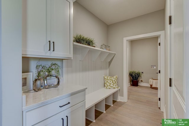 mudroom with baseboards and light wood-type flooring