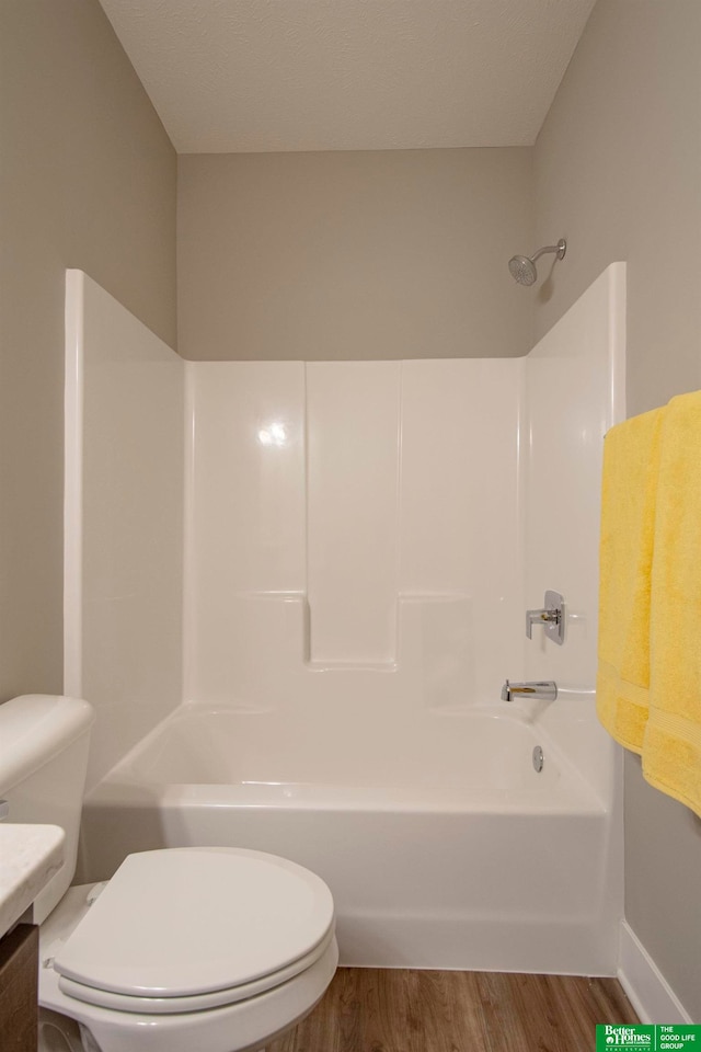 full bathroom with shower / washtub combination, hardwood / wood-style flooring, toilet, and vanity