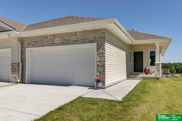 view of side of property with a garage and a lawn