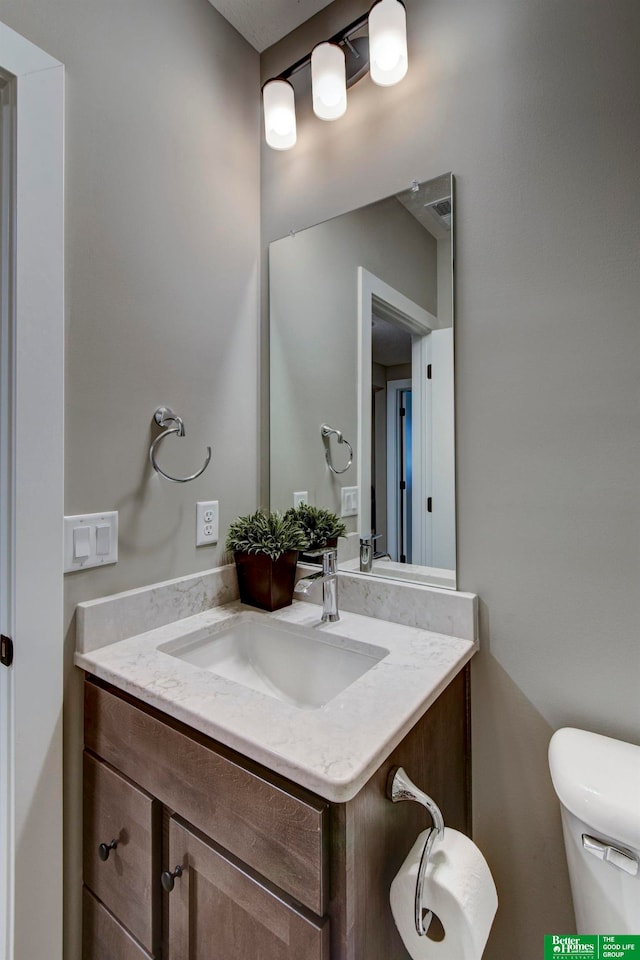 bathroom featuring vanity and toilet