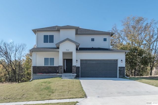 view of front of property with a garage and a front lawn