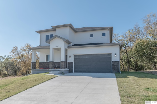 view of front of property with covered porch, a garage, and a front lawn