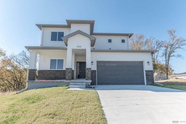 view of front of home featuring a front yard and a garage