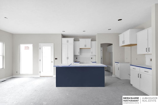 kitchen featuring white cabinets and a center island