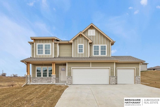 view of front of property with a porch, a garage, and a front yard