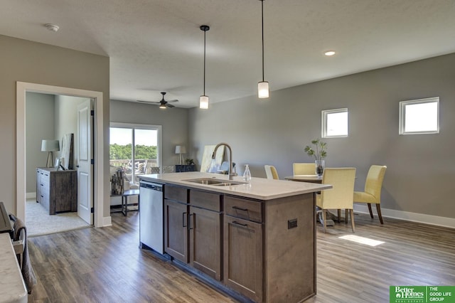 kitchen featuring wood finished floors, dishwasher, a sink, and a ceiling fan