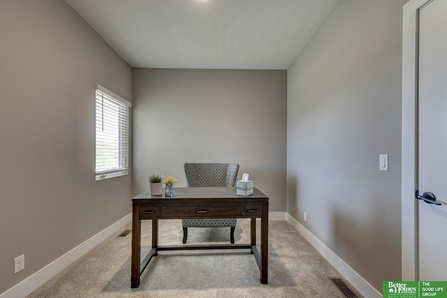 carpeted office space featuring visible vents and baseboards