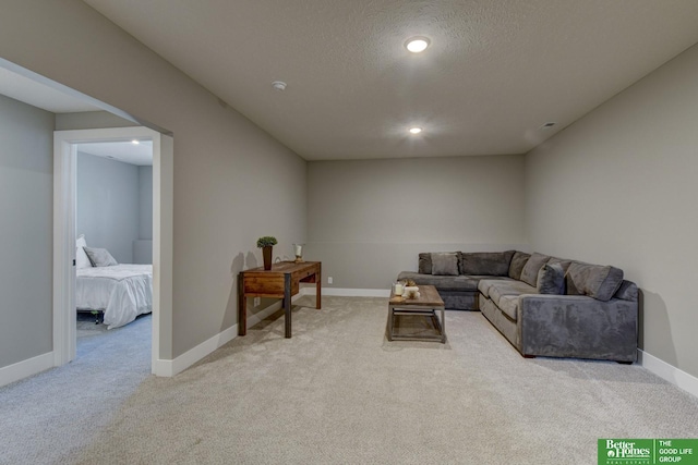 living room with light carpet, recessed lighting, baseboards, and a textured ceiling