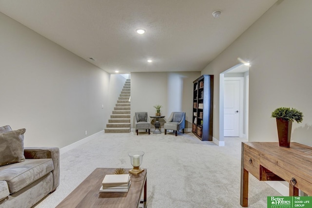 living area featuring recessed lighting, stairs, carpet flooring, and a textured ceiling