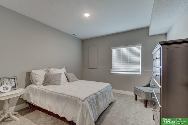 bedroom with carpet flooring, visible vents, baseboards, and a textured ceiling