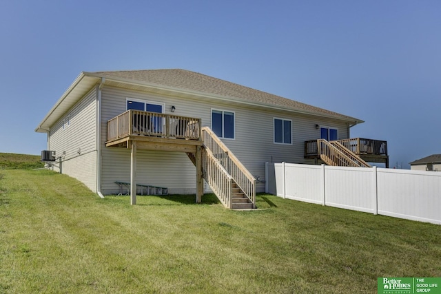 back of property featuring central AC, a yard, a wooden deck, and stairway