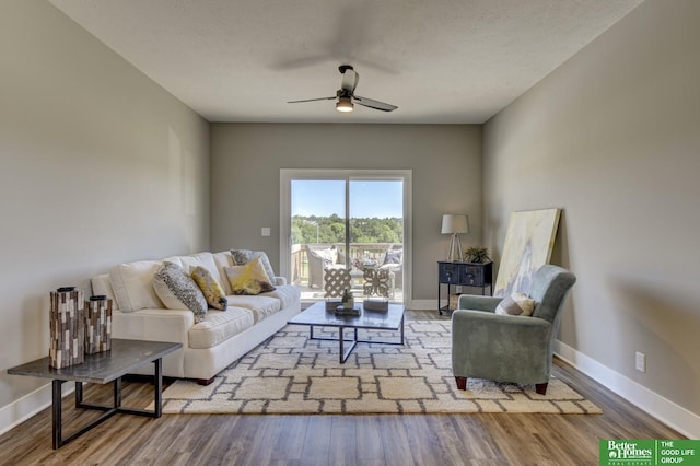 living room with ceiling fan, wood finished floors, and baseboards
