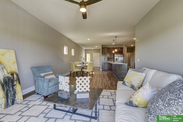 living area with recessed lighting, baseboards, a ceiling fan, and wood finished floors