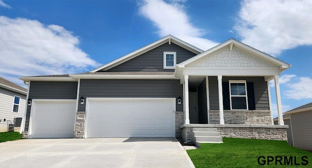 craftsman inspired home featuring covered porch and a garage