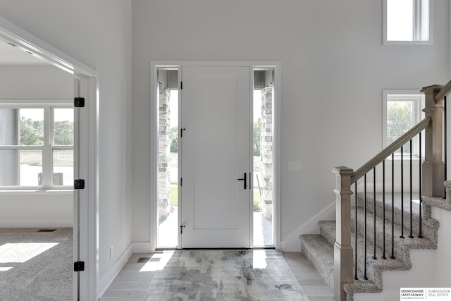 entryway with light hardwood / wood-style flooring and a wealth of natural light