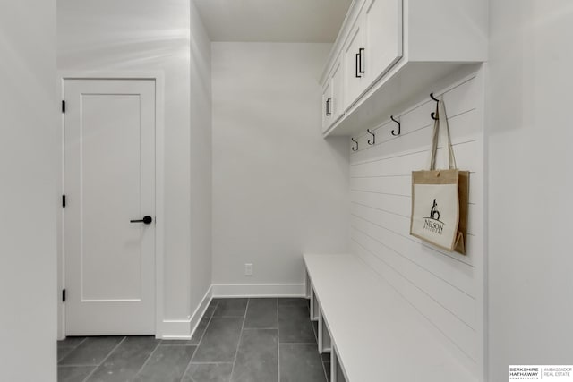 mudroom featuring dark tile patterned floors