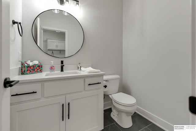 bathroom with tile patterned floors, vanity, and toilet