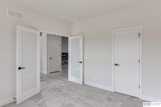 unfurnished bedroom featuring light colored carpet