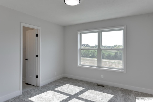 unfurnished room with light carpet