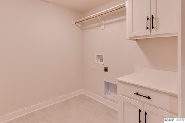 clothes washing area featuring hookup for an electric dryer, hookup for a washing machine, and cabinets