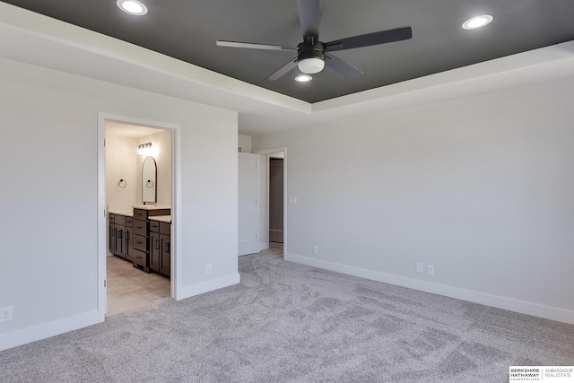 unfurnished bedroom featuring ceiling fan, connected bathroom, and light carpet