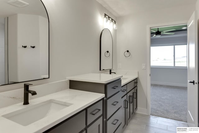 bathroom featuring ceiling fan, vanity, and wood-type flooring