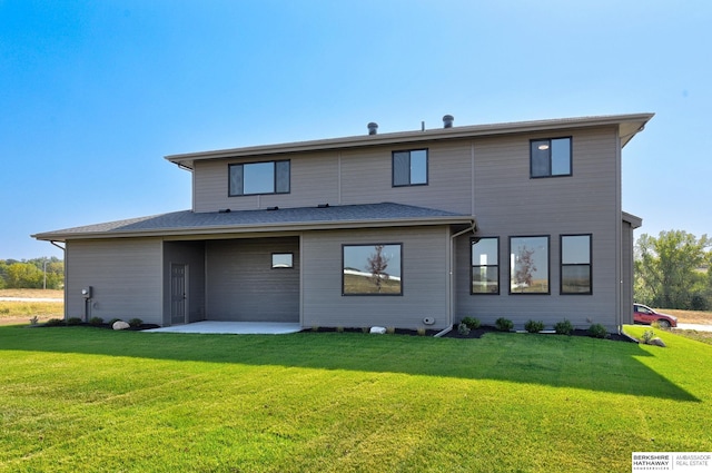 back of property featuring a patio and a yard