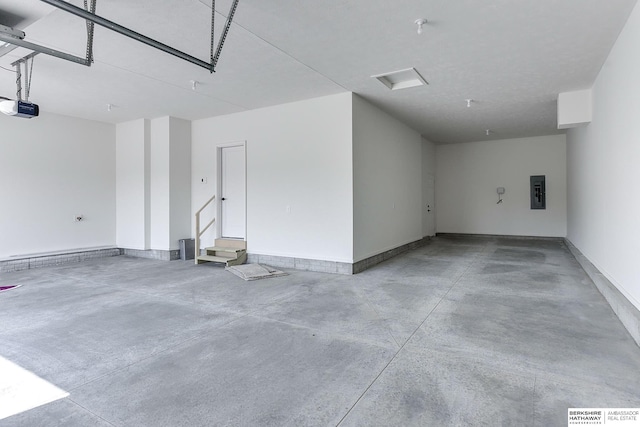 garage with a garage door opener and electric panel