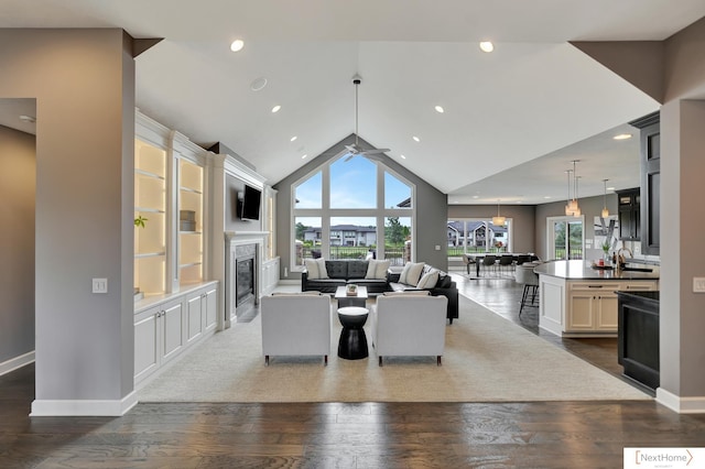 living room with a fireplace, hardwood / wood-style floors, plenty of natural light, and ceiling fan