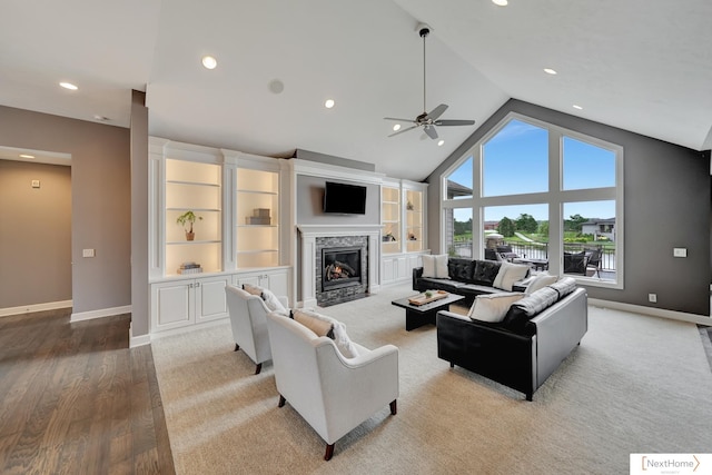 living room featuring ceiling fan, high vaulted ceiling, and light hardwood / wood-style flooring