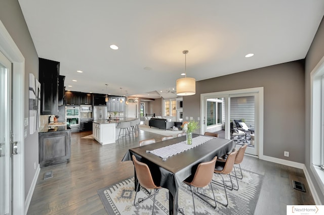 dining area with dark hardwood / wood-style floors